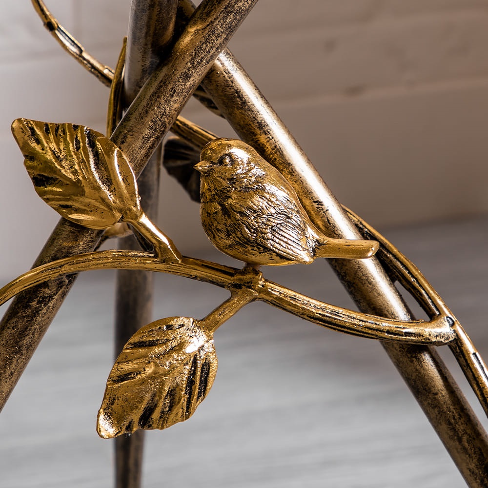 Фрагмент опоры стола: элементы декора - птичка на ветви. Фото в интерьере.