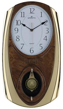 Часы настенные с овальным циферблатом и маятником.